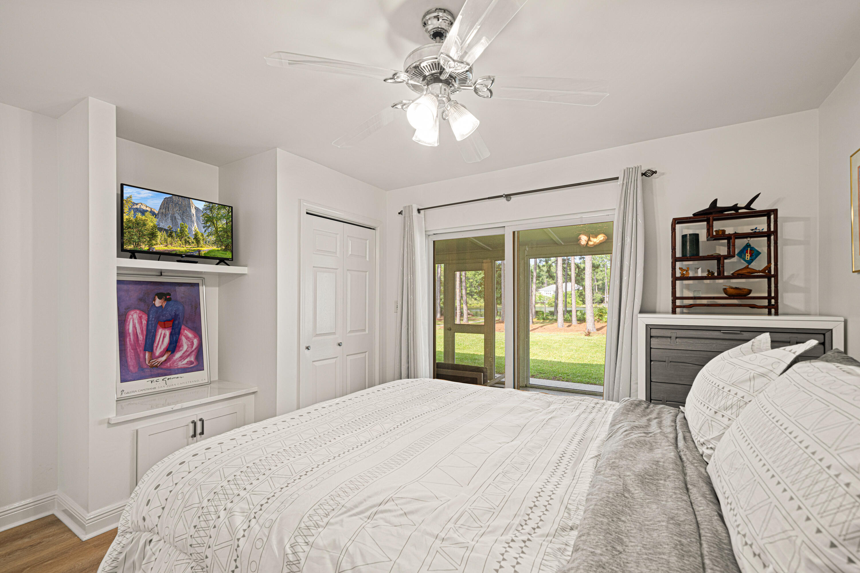 216 Santa Barbara Avenue Santa Rosa Beach, FL 32459 - Photo 37 of 85 a bedroom with a bed and a chandelier