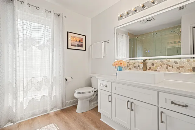 a kitchen with a dining table chairs and white cabinets