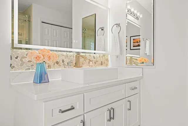 a spacious bedroom with a bed and a ceiling fan