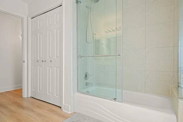 a bathroom with a sink a mirror and a shower