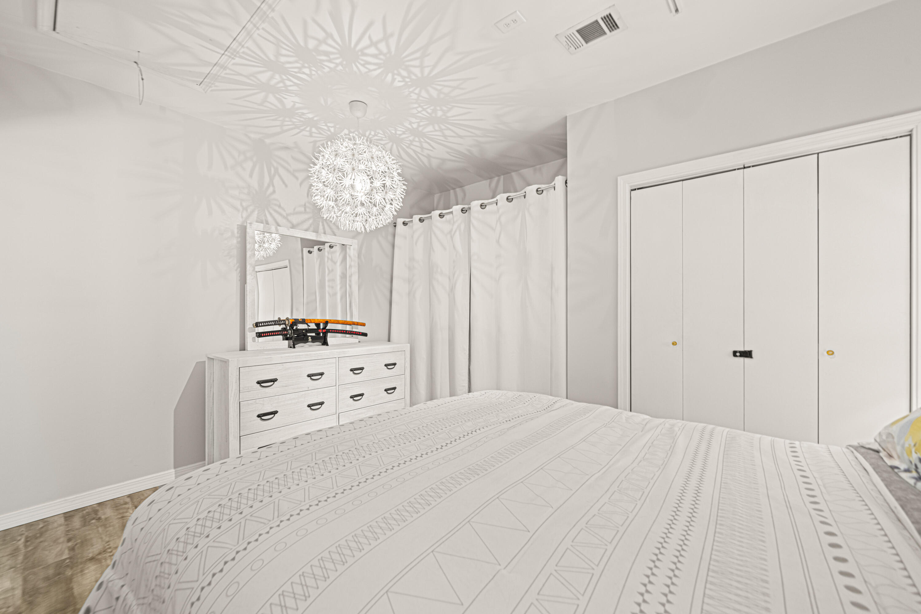 216 Santa Barbara Avenue Santa Rosa Beach, FL 32459 - Photo 55 of 85 a bedroom with a bed and a chandelier