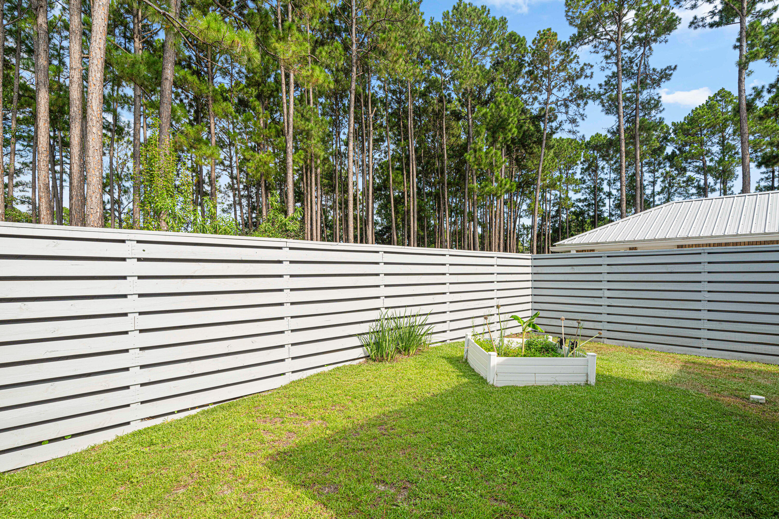 216 Santa Barbara Avenue Santa Rosa Beach, FL 32459 - Photo 70 of 85 a view of a chair and table in the backyard