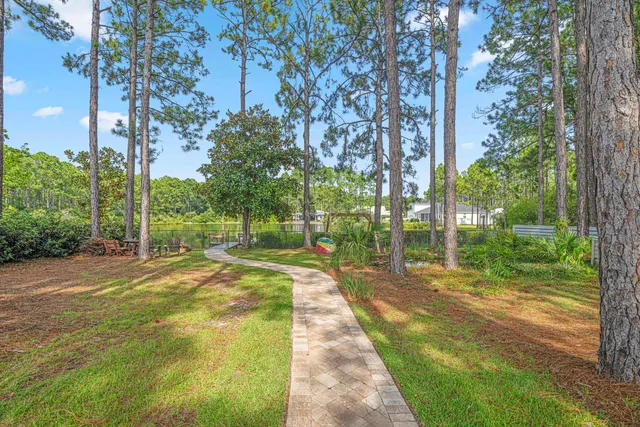 an aerial view of residential houses with outdoor space and trees