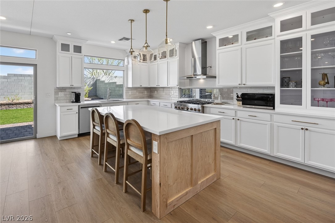 10446 Emerald Rye Street Las Vegas, NV 89183 - Photo 14 of 37 A spacious kitchen with an extended island offers abundant counter space and modern amenities.