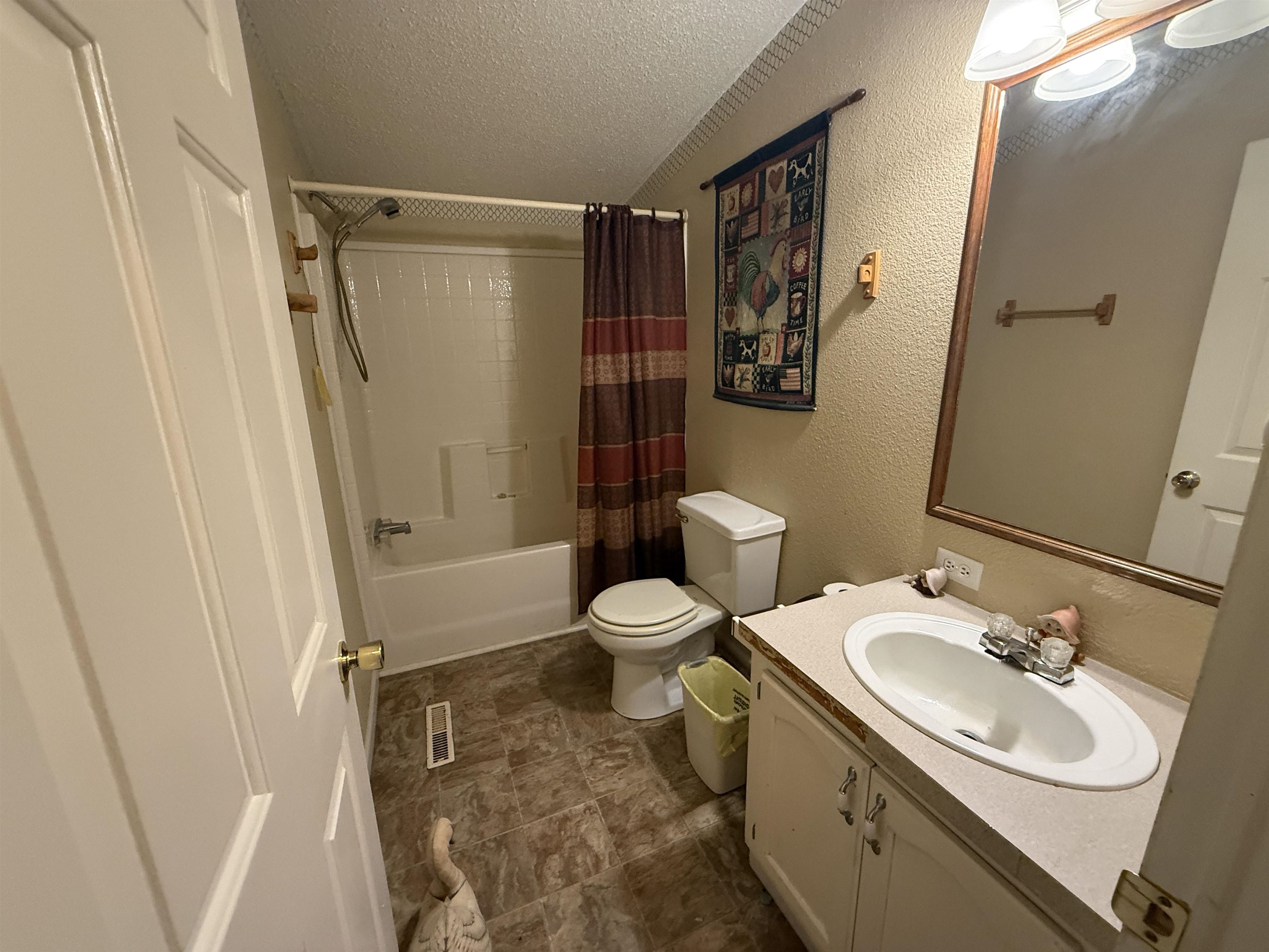 2201 Robert Johnson Road Covington, TN 38019 - Photo 21 of 25 Bathroom featuring a white vanity with a laminate countertop and an oval sink
