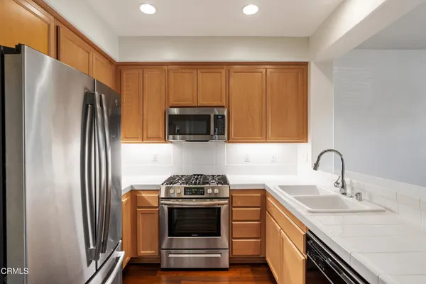 a kitchen with a sink stove and microwave