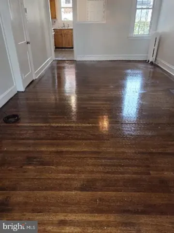 a view of room with window and wooden floor