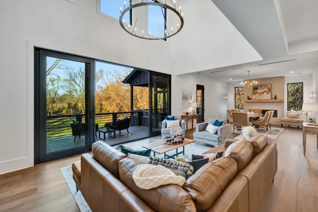 a spacious bedroom with a large bed and a chandelier