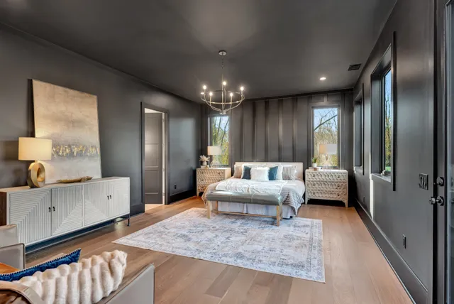a living room with patio furniture and a floor to ceiling window