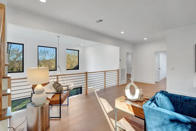 a view of a house with a yard and a large tree