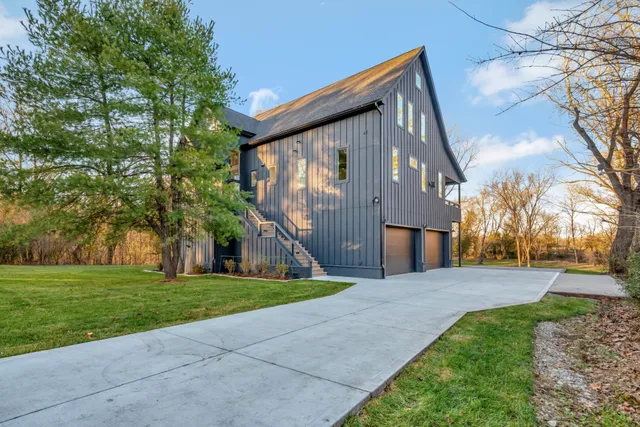 a large kitchen with stainless steel appliances granite countertop a stove a sink and a refrigerator with wooden floors