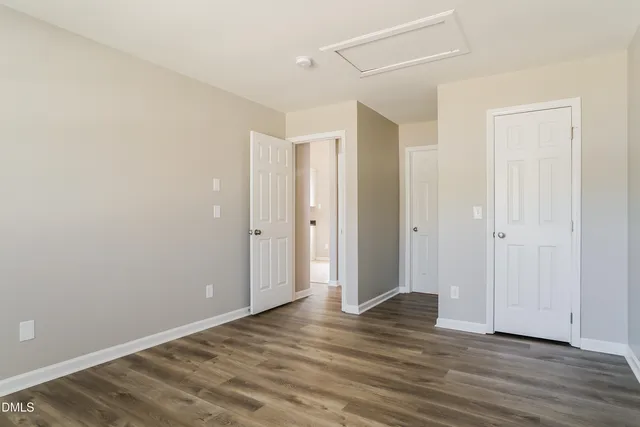 a view of an empty room and wooden floor