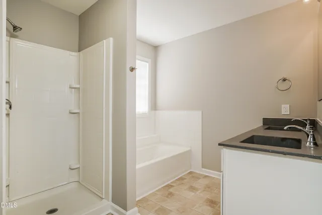 a bathroom with a bathtub and shower