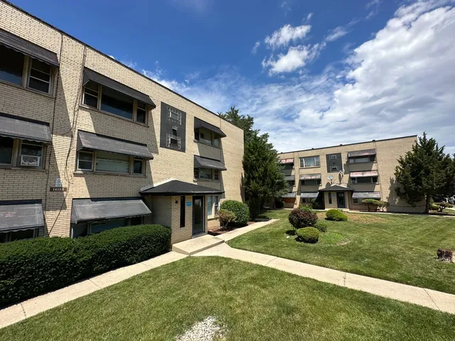 a front view of a house with a yard garage and outdoor seating