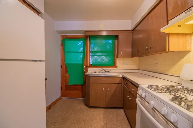 a kitchen with a sink and a stove top oven