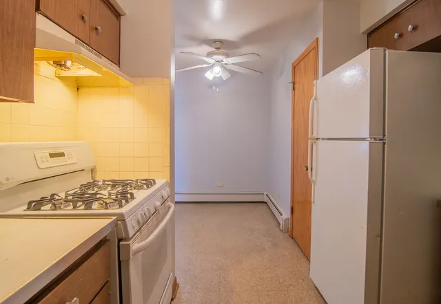 a view of kitchen with stainless steel appliances granite countertop cabinets and a refrigerator