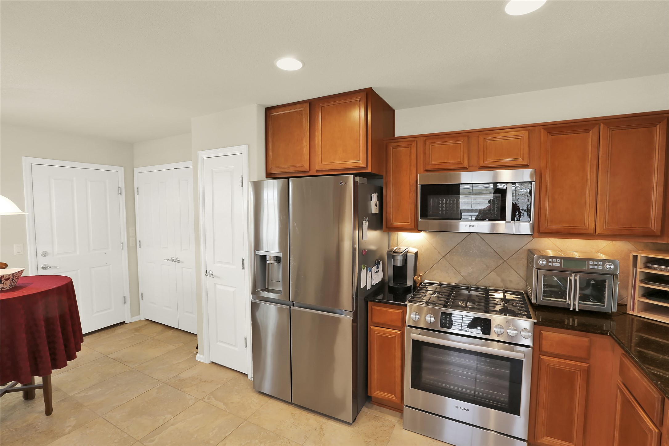 104 Sheldon Lake Drive Georgetown, TX 78633 - Photo 4 of 40 a kitchen with stainless steel appliances granite countertop a refrigerator stove and microwave