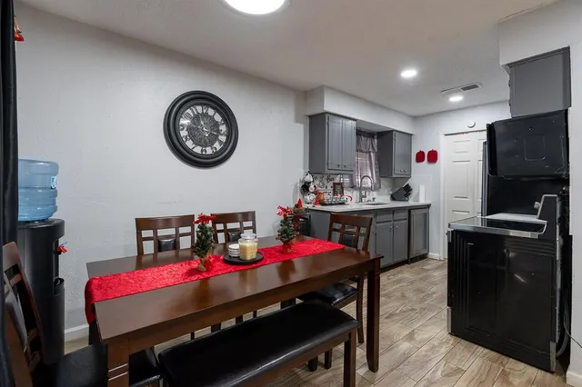 a kitchen with stainless steel appliances kitchen island granite countertop a dining table and chairs