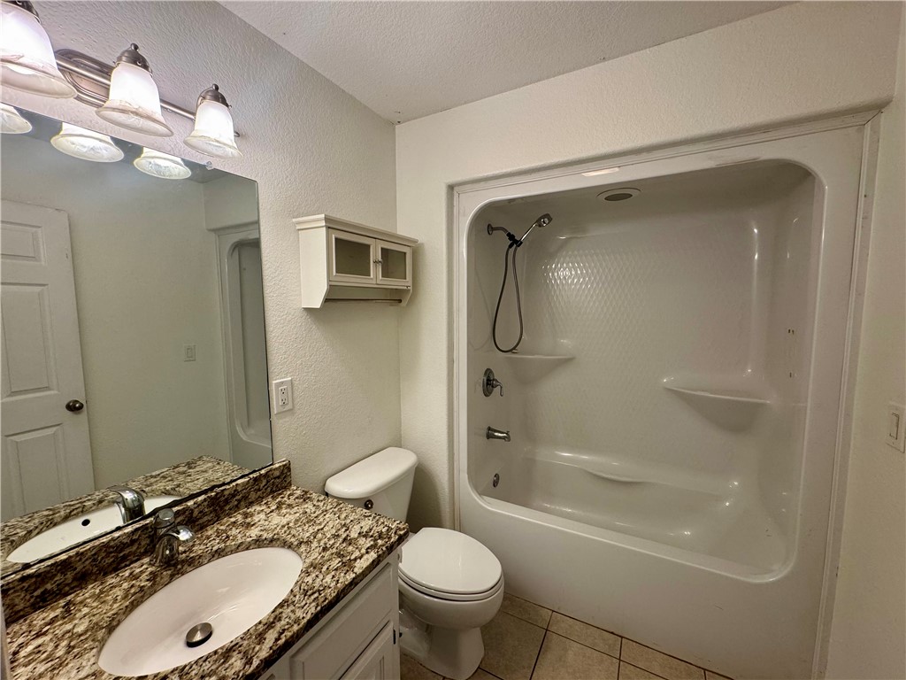 1197 Ridgeview Lane Russellville, AR 72802 - Photo 18 of 44 Bathroom featuring a single vanity with a patterned countertop and undermount sink, a large mirror, a built-in wall cabinet, and a white tub/shower combination