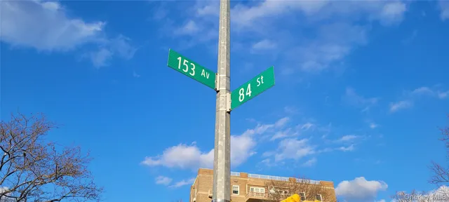 a street sign on a wall next to a wall