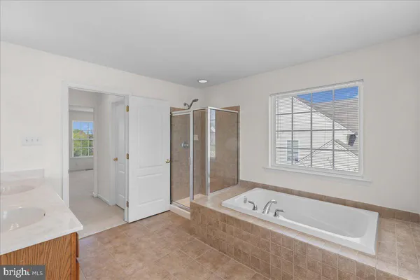 a spacious bathroom with a double vanity sink mirror and a toilet