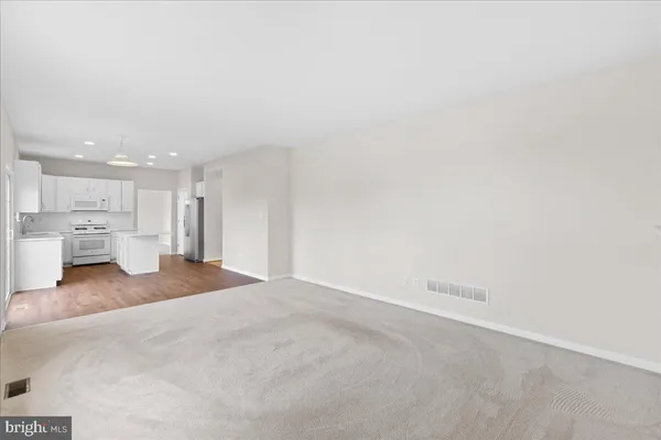a kitchen with a sink windows and white cabinets
