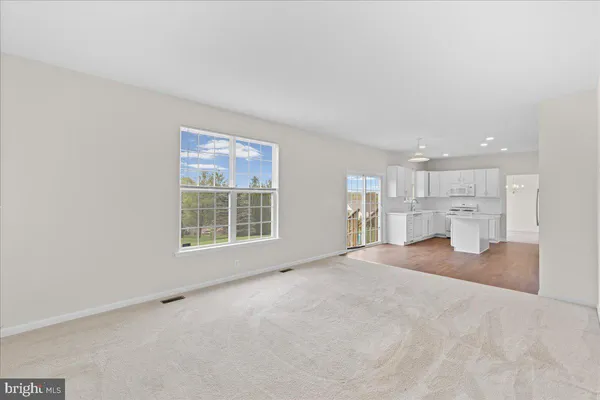 a large kitchen with kitchen island a sink stainless steel appliances and cabinets