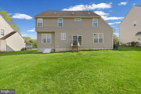 a front view of house with yard and outdoor seating