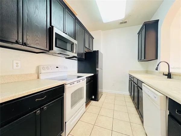 a kitchen with a refrigerator sink and microwave