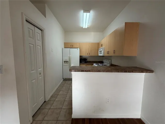 a view of a refrigerator a sink and dishwasher