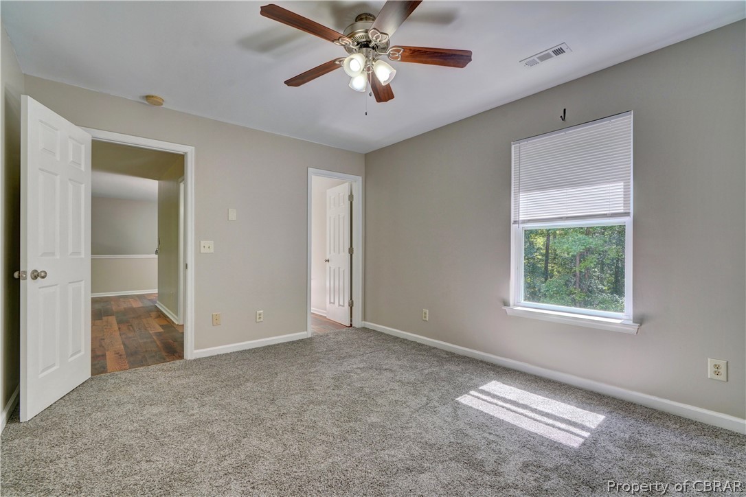 8269 Ark Road Gloucester, VA 23061 - Photo 17 of 33 Unfurnished bedroom featuring hardwood / wood-style flooring and ceiling fan