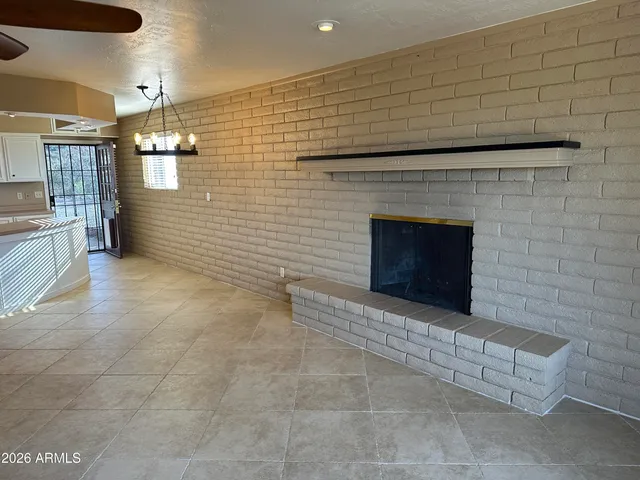 a view of a livingroom with a fireplace and window