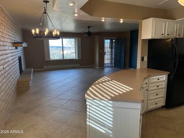 a kitchen with stainless steel appliances granite countertop a sink dishwasher a stove and a refrigerator