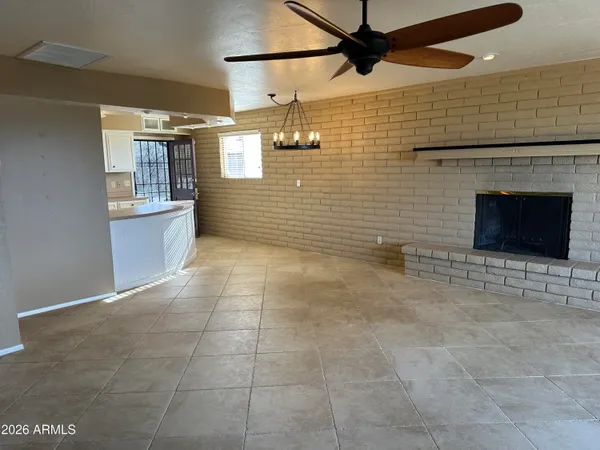 a view of a livingroom with a ceiling fan and window