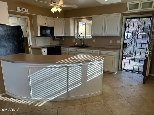 a kitchen with stainless steel appliances granite countertop a refrigerator sink and cabinets