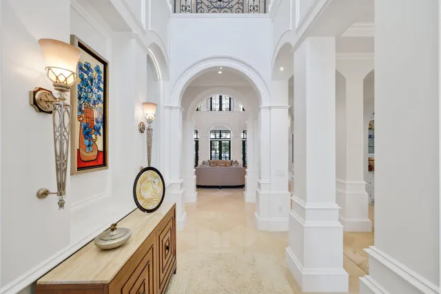 a kitchen with stainless steel appliances kitchen island granite countertop a table chairs and white cabinets