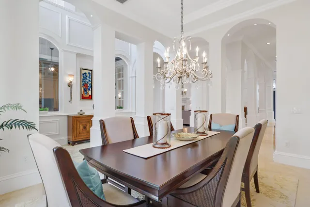a kitchen with granite countertop a sink white cabinets and a window