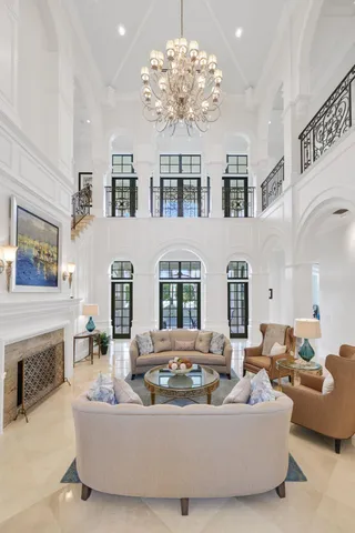 a view of a dining room with furniture and a chandelier