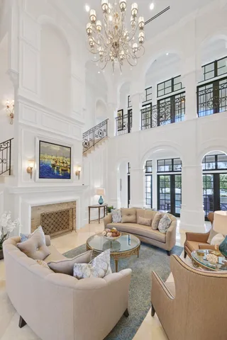 a living room with furniture flat screen tv and a large window