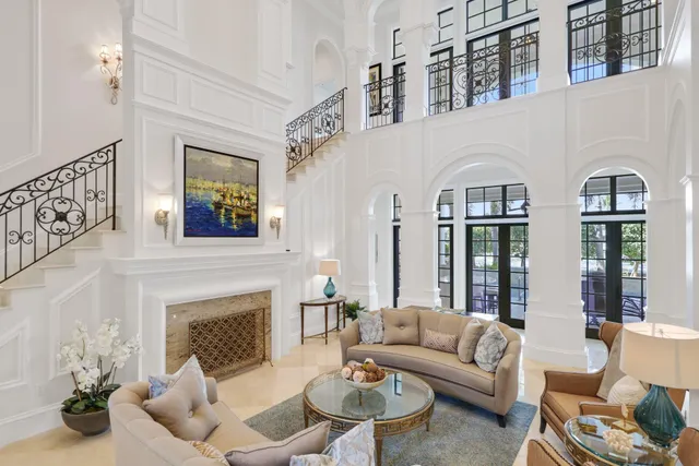 a living room with furniture a flat screen tv and a large window