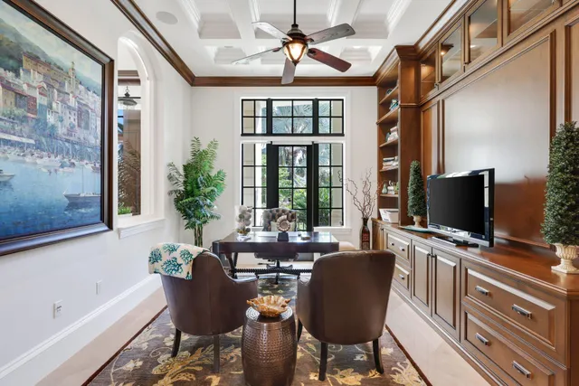 a view of a dining room with furniture and a potted plant