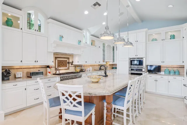 a spacious bedroom with a large bed and a chandelier