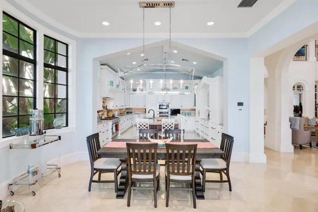 a dining room with furniture a chandelier and wooden floor