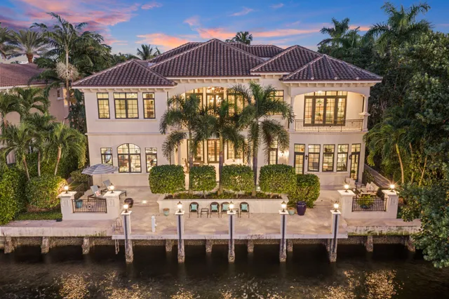 a view of a dining room with furniture a chandelier and wooden floor