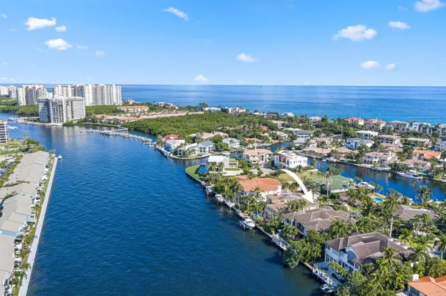 a living room with furniture a fireplace and a large window with wooden floor