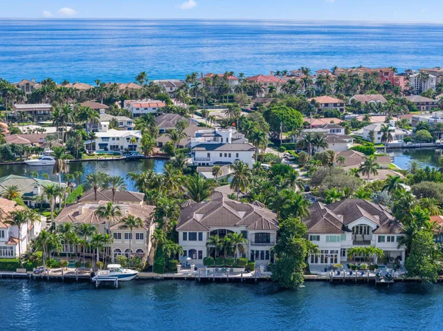 a living room with furniture a fireplace and a chandelier