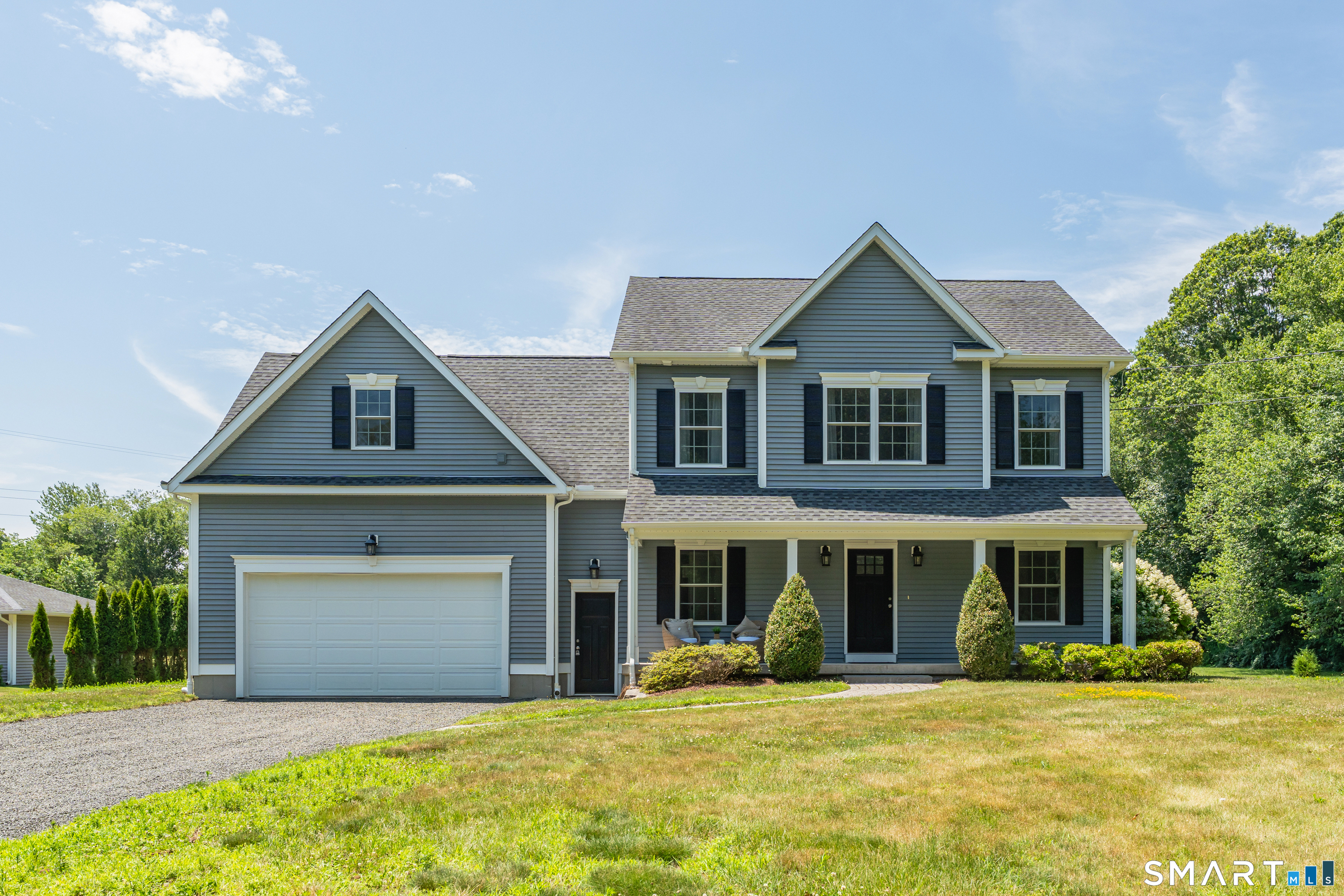 838 Little Meadow Road Guilford, CT 06437 - Photo 2 of 40 This view shows the covered front porch and oversized 2 car garage that leads to the mudroom entrance to the home.