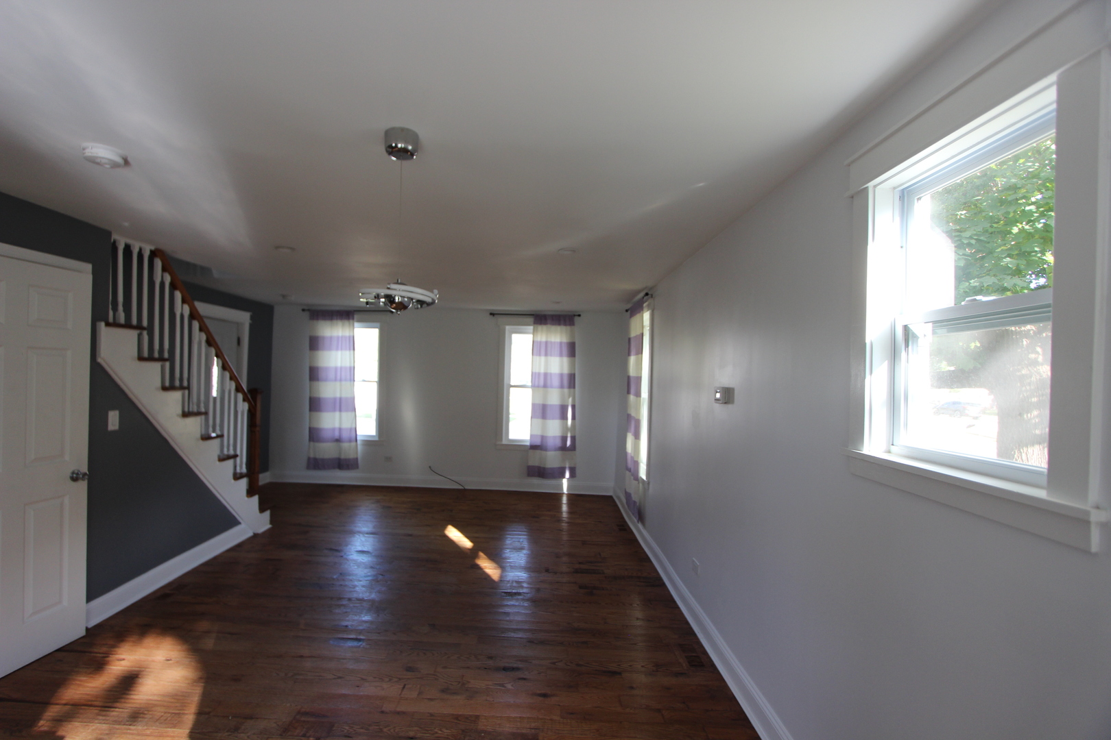 633 1/2 Whitney Boulevard Belvidere, IL 61008 - Photo 4 of 16 a view of empty room with wooden floor and fan