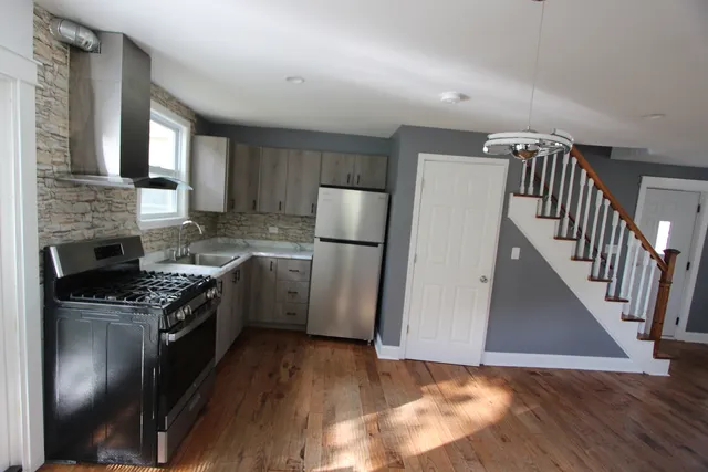 a kitchen with a stove a refrigerator and a sink