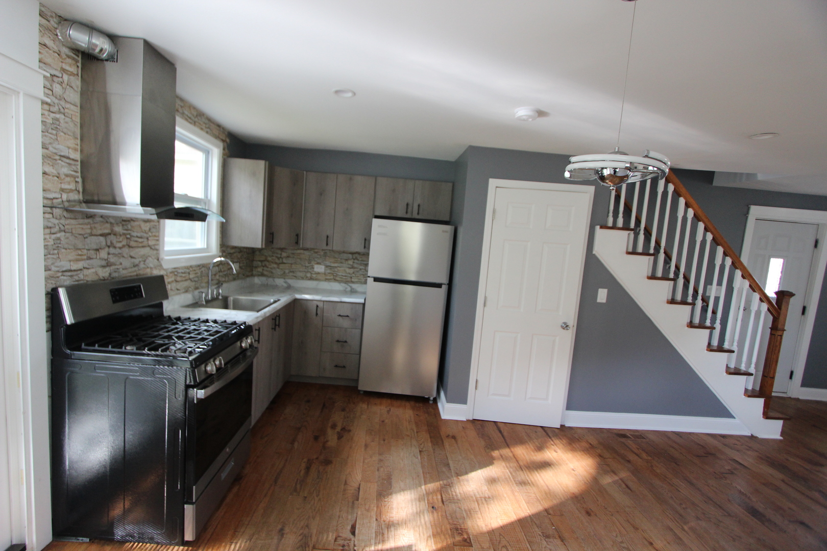 633 1/2 Whitney Boulevard Belvidere, IL 61008 - Photo 5 of 16 a kitchen with a stove a refrigerator and a sink